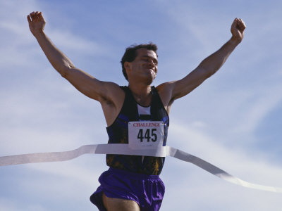 male-runner-victorious-at-the-finish-line-in-a-track-race.jpg